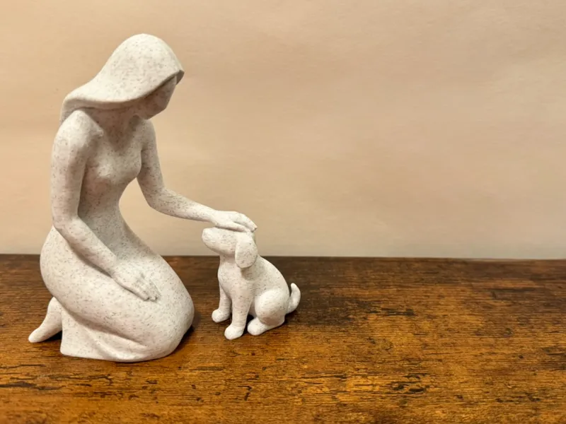 Gentle Moments: Woman Petting Puppy Sculpture