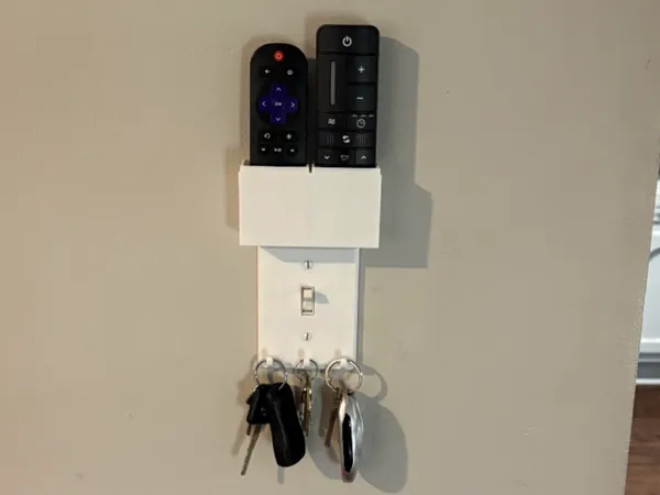 Cache-interrupteur avec rangement pour 2 télécommandes