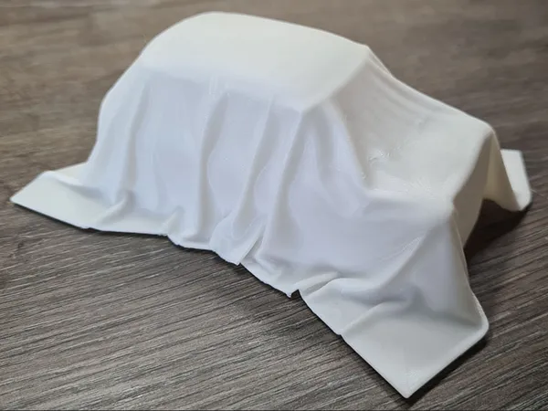 Sculpture voiture voilée en tissu