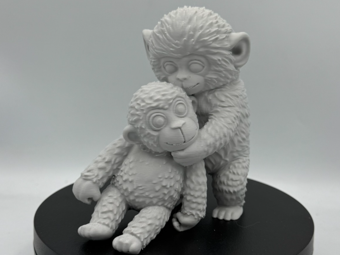 Punch The Baby Monkey Cuddling a Stuffed Monkey