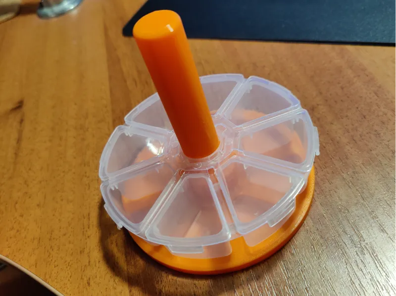Vertical holder for round storage boxes