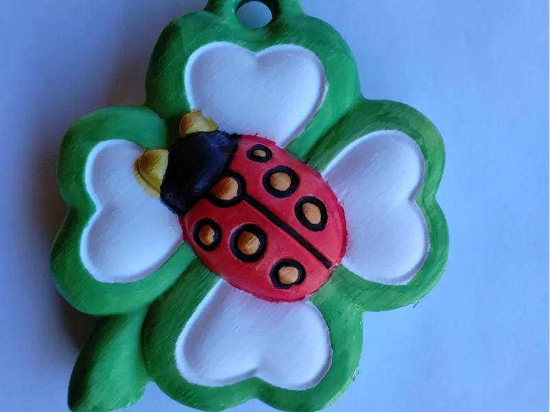 Four-leaf clover with ladybird with 7 lucky dots.