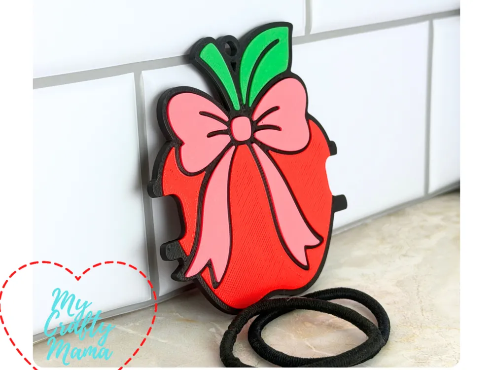 Accesorio para sujetar ligas de cabello: School teacher apple with bow hair tie keychain. Referencia del modelo original.