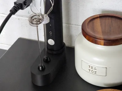 Milk frother stand with attachment slots