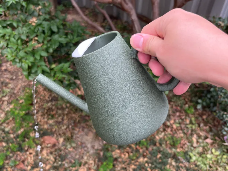 Watering can with fuzzy skin