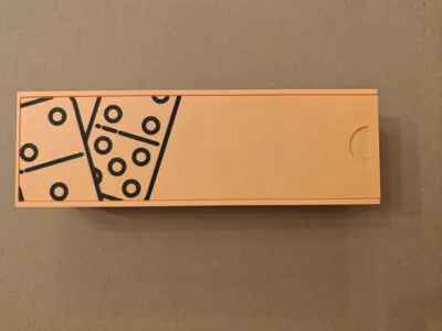 thick dominoes with a textured logo on the box lid