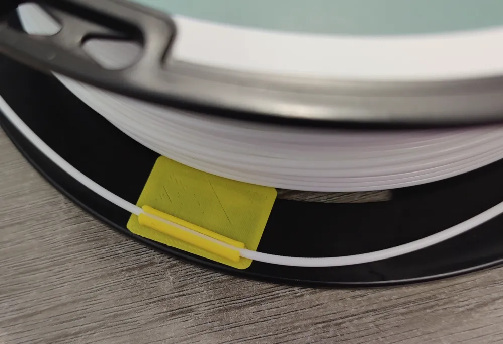 Adhesive angled filament clip with doublesided tape cutting jig by