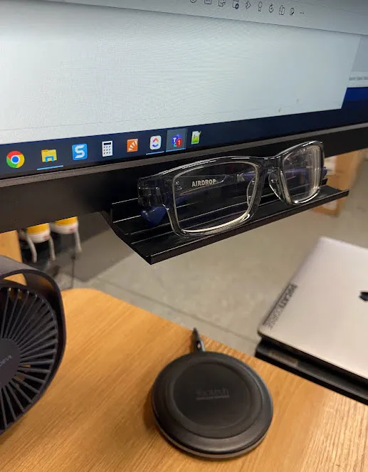 Under monitor eyeglasses holder