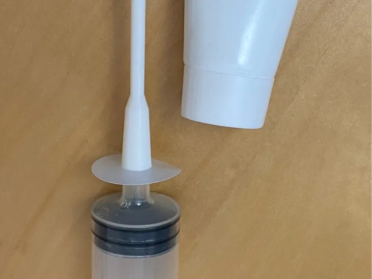 Syringe adapter to fill cream tubes