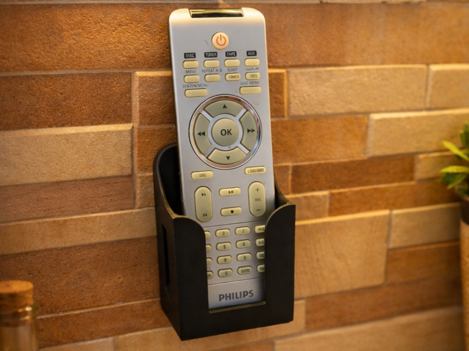 Universal wall-mounted holder for remote
