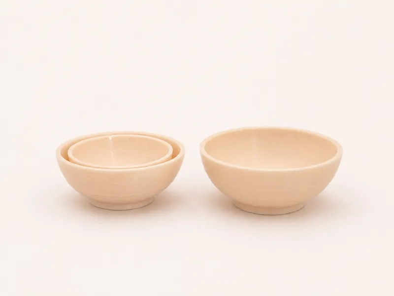 A bowl and tableware suitable for a dollhouse.