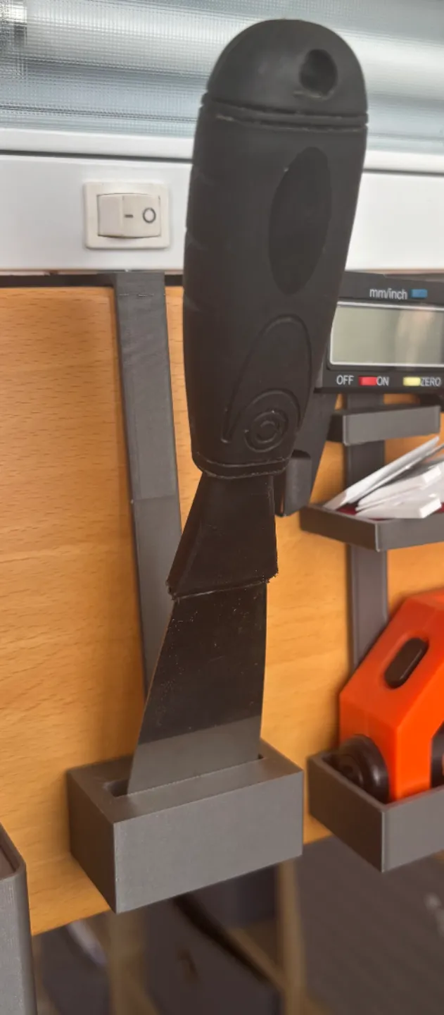 Scraper holder for lip.
