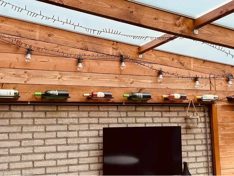 Modern wall bracket for wine / beverage bottles.