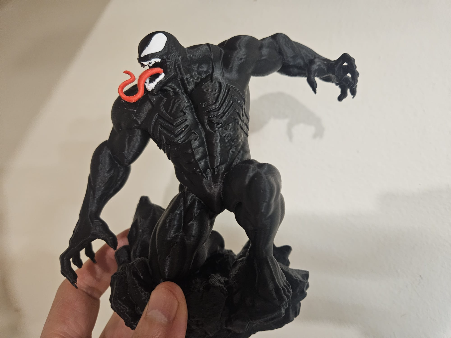 venom in a dynamic pose with rock base