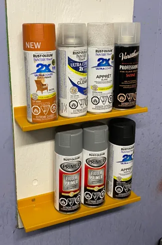 Spray can shelf