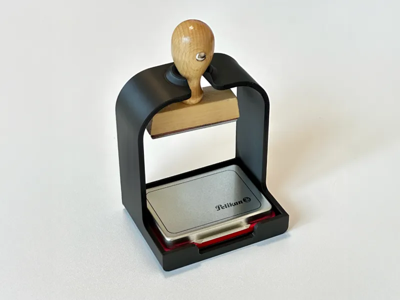 Stamp holder with ink pad compartment