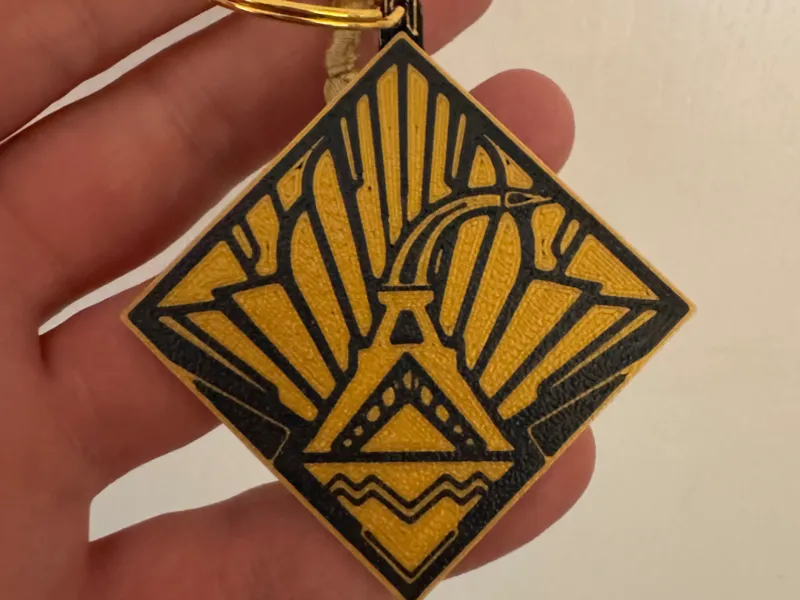 Porte clé emblème de Lumiere clair obscur 