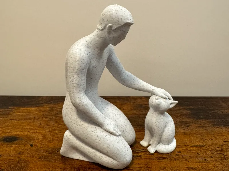 Gentle Moments: Man Petting Cat Sculpture