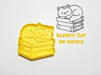 Emporte-pièce et tampon chat endormi sur livres — photo 1