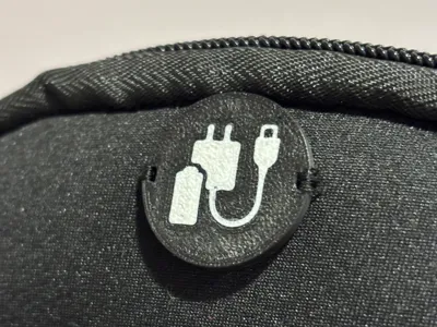 Charge cable badge/button for pouch/bag