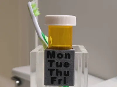 Pill bottle hanger for toothbrush cups