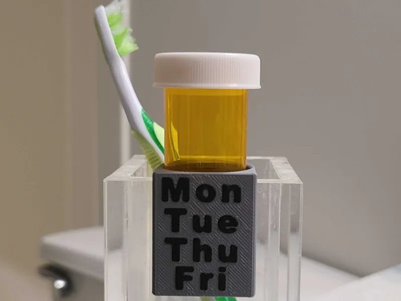 Pill bottle hanger for toothbrush cups
