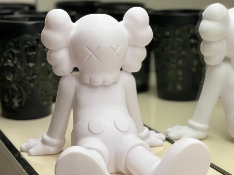 Kaws figure sitting