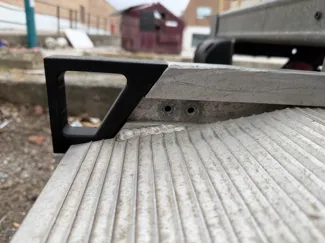 Handle for moving truck ramp