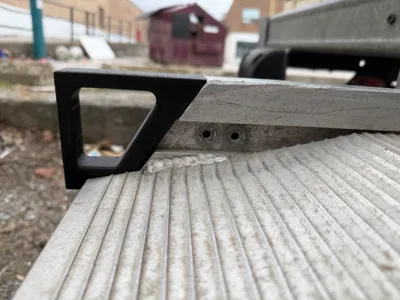 Handle for moving truck ramp