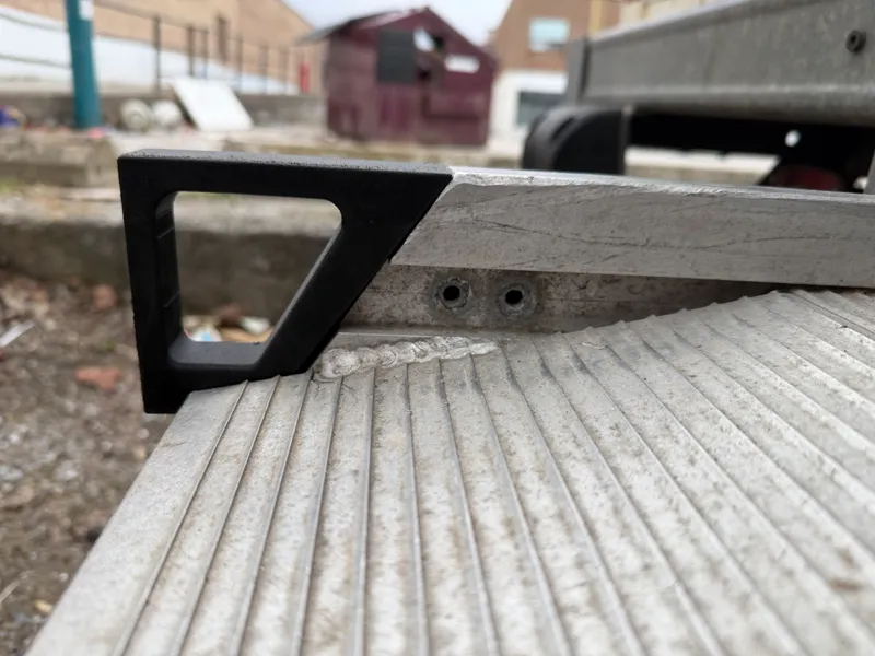 Handle for moving truck ramp