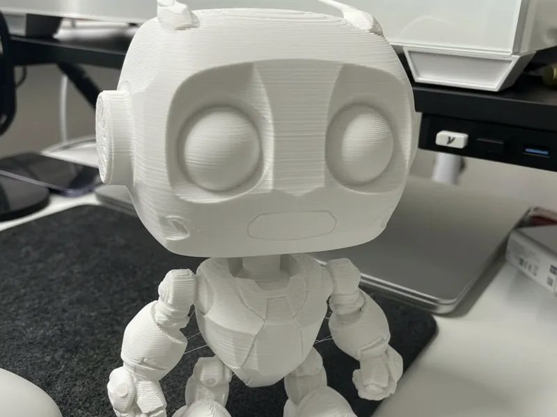 Smiley Chibi Bot: Adorable Robot Figurine!