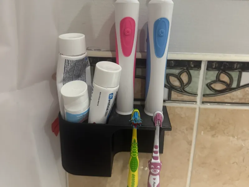 Toothbrush holder with toothpaste pocket