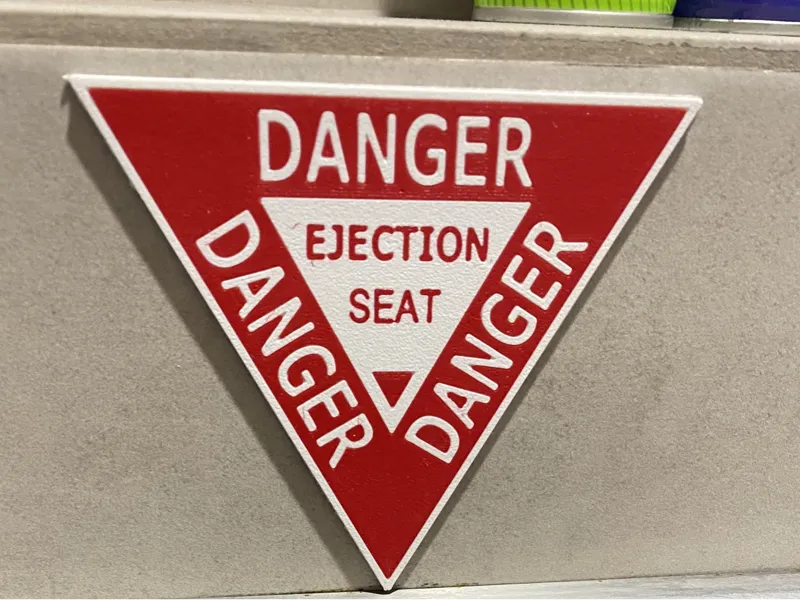 Ejection seat label for toilet