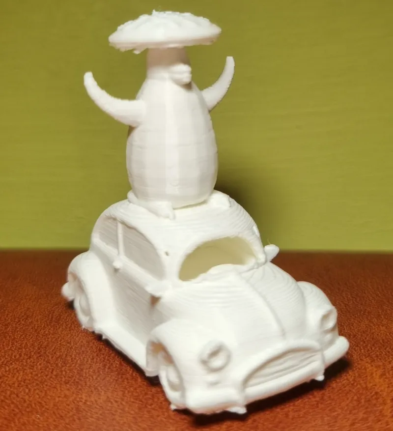 Penguin with a Pizza on its head on top of a car 