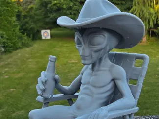 Alien in chair with beer and Hat