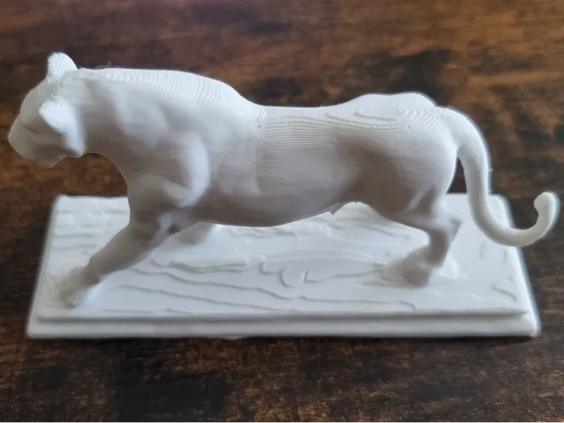 Tiger sculpture with base