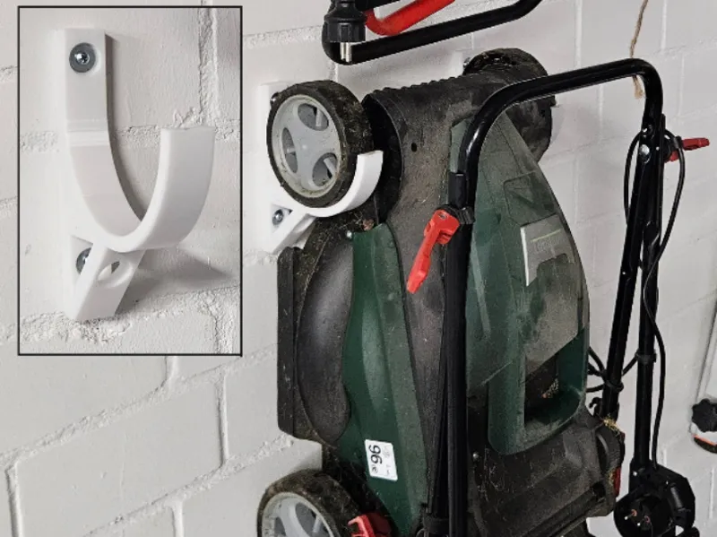 Wall mounting for lawn mowers or scarifiers