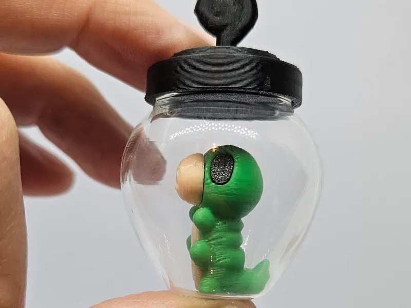 Tiny Hollow Knight Grub in a Bottle