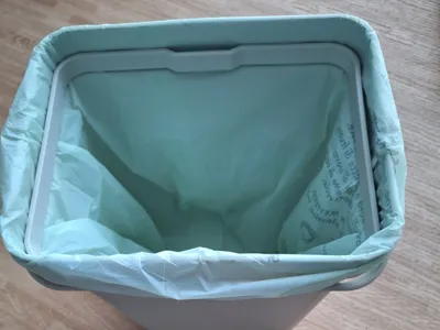 Raised base for recycling bin