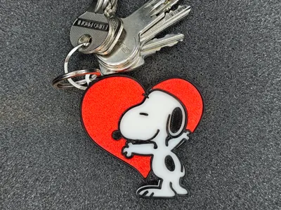 Snoopy hugging a heart keychain
