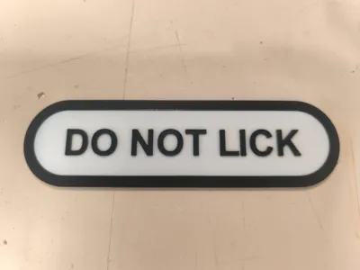 DO NOT LICK sign