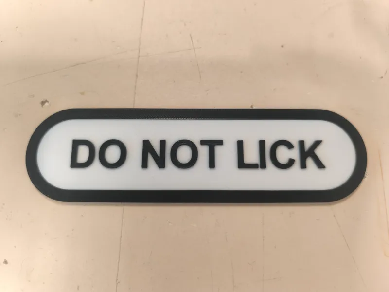 DO NOT LICK sign