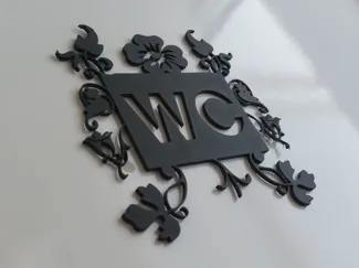 WC sign with leaf decoration