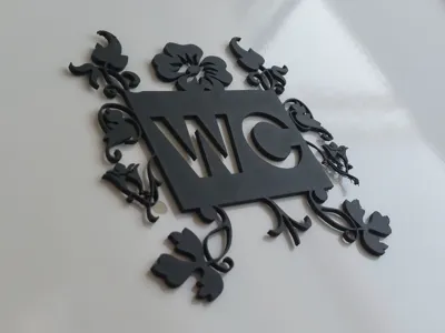 WC sign with leaf decoration