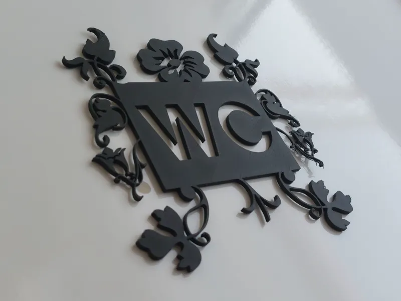 WC sign with leaf decoration