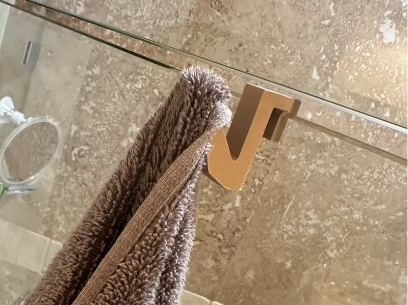 Space-saving towel hook for frameless shower door