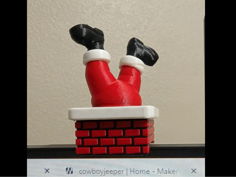 Monitor decoration santa legs out of chimney