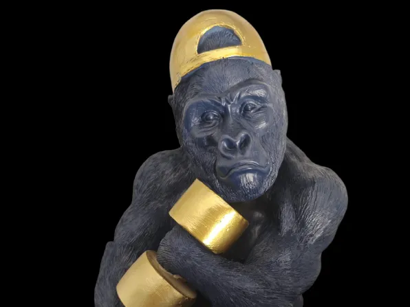 decorative bust of a gorilla with a barbell
