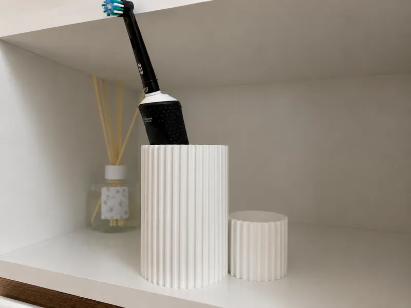A modern container for toothbrushes and toothpaste