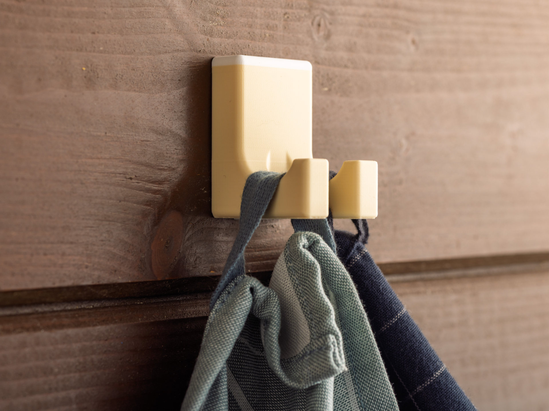 Wall hanger with two hooks and hidden screws.